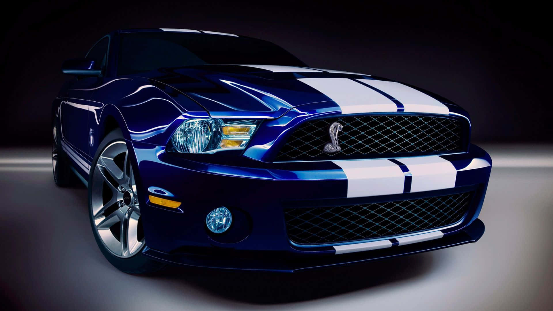 A Blue And White Ford Mustang Is Shown In A Dark Room Wallpaper