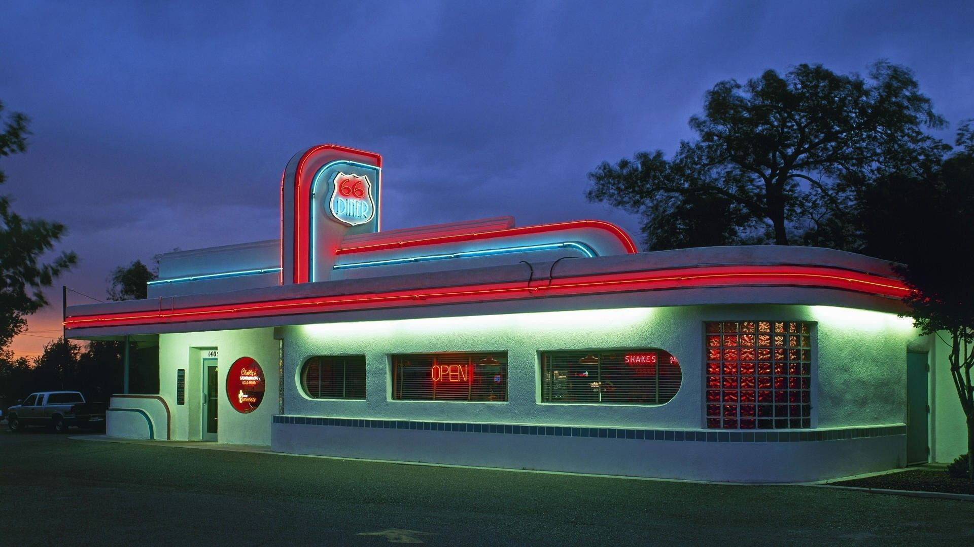 A Vibrant Night at an Iconic 50s Diner Wallpaper