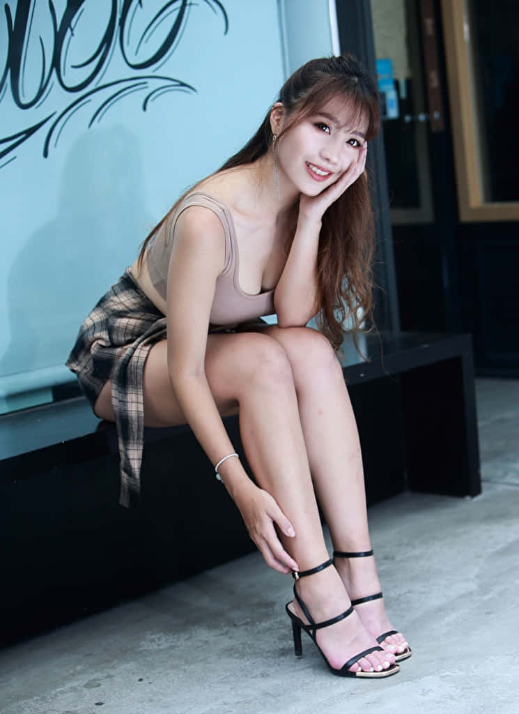 Elegant Asian Woman Showcasing Healthy White Thighs Wallpaper