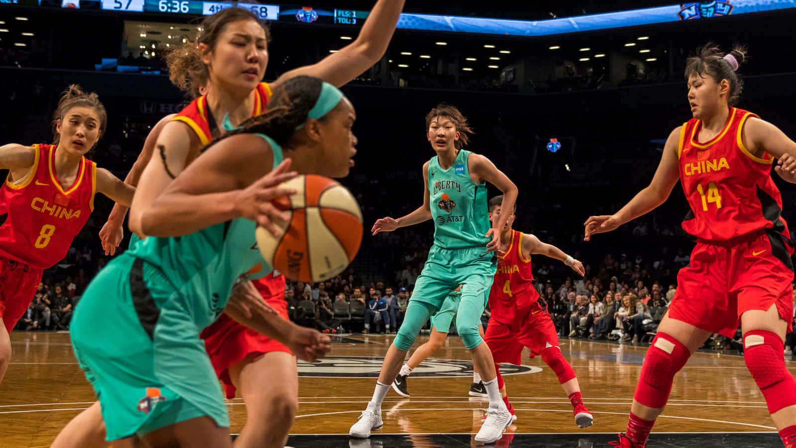 A Group Of Women Basketball Players Are Playing A Game