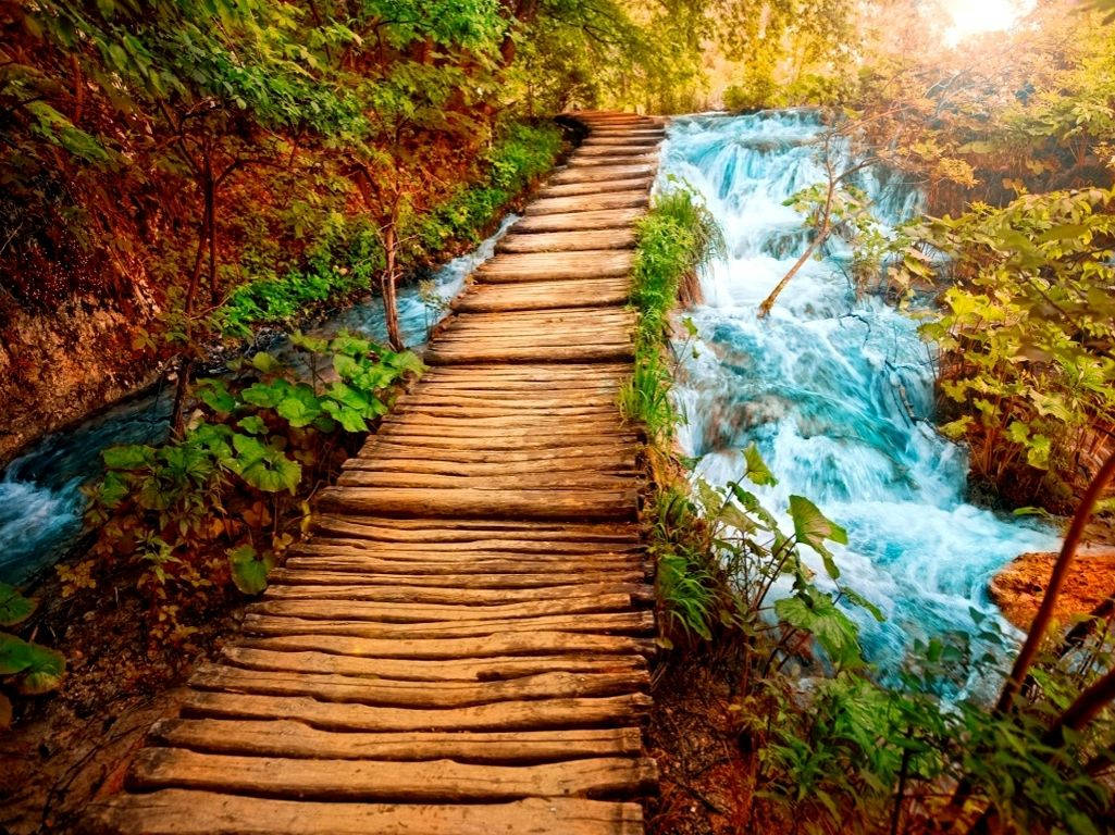 A beautiful bridge crossing a tranquil river Wallpaper