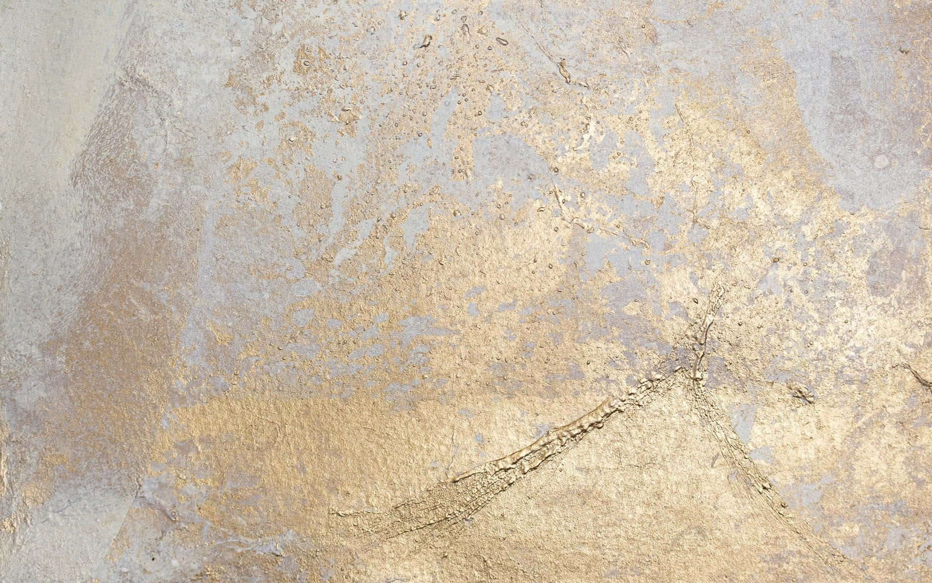 a close up of a gold and silver painted wall