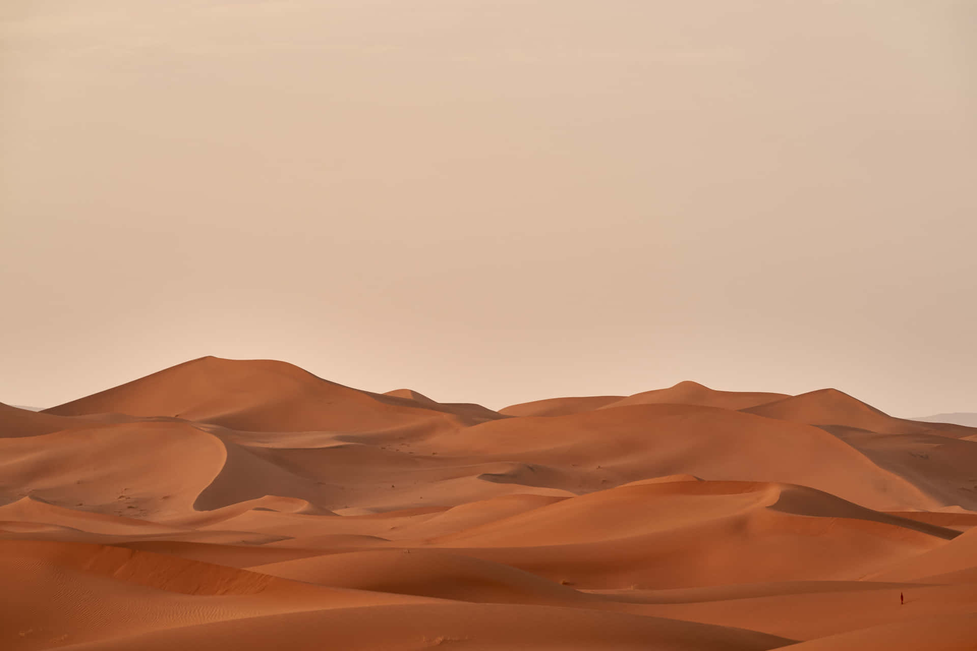 A Desert Landscape With Sand Dunes And A Sandstorm
