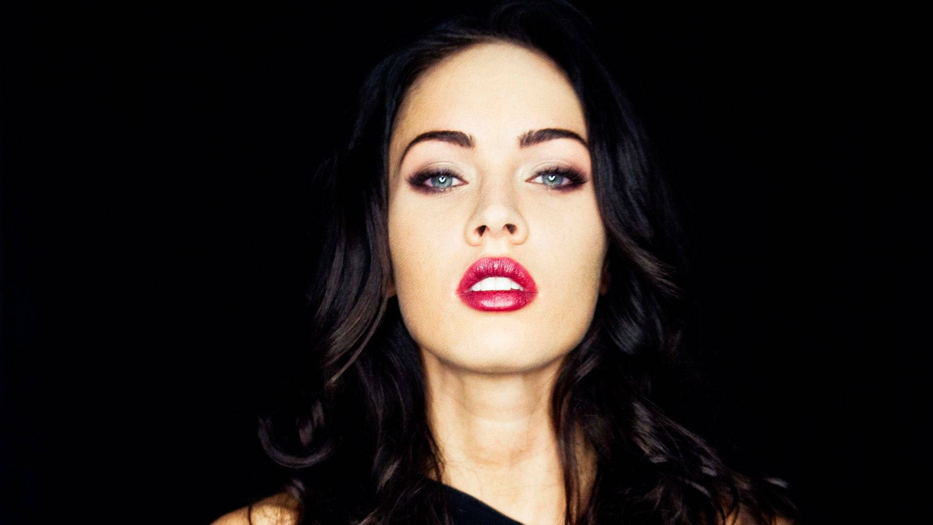 Megan Fox looking seductive with her signature red lips Wallpaper