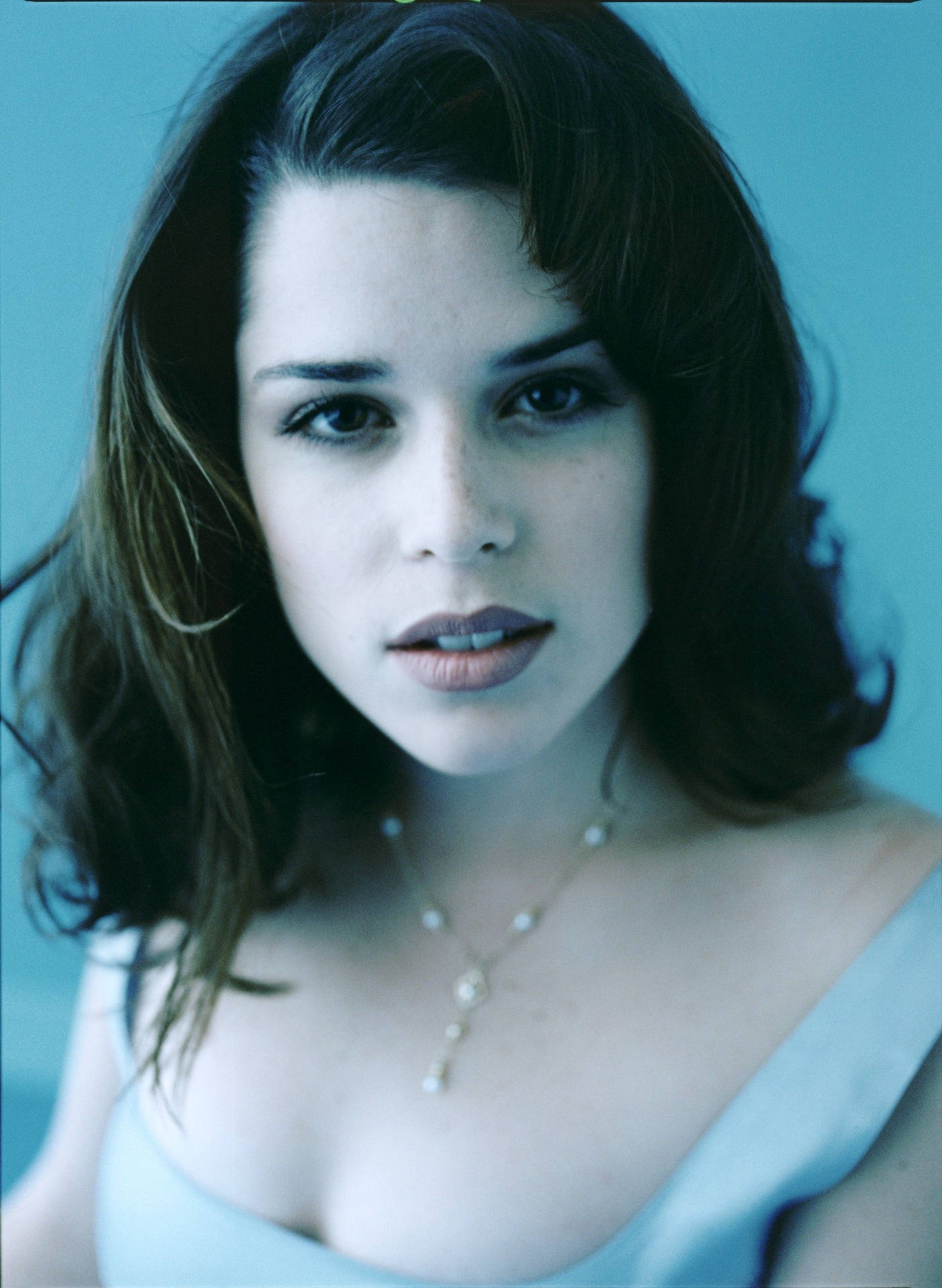Elegance Personified: Neve Campbell in a Blue Top Wallpaper
