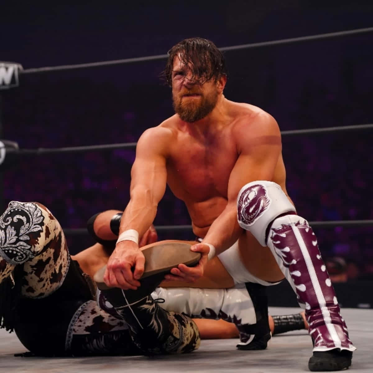 Intense Action with Bryan Danielson in a Wrestling Match Wallpaper