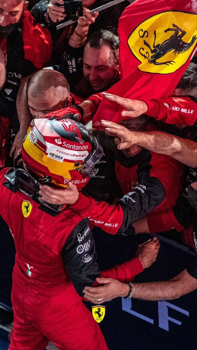 Caption: Triumphant Moment of Carlos Sainz Jr. After a Glorious Victory Wallpaper