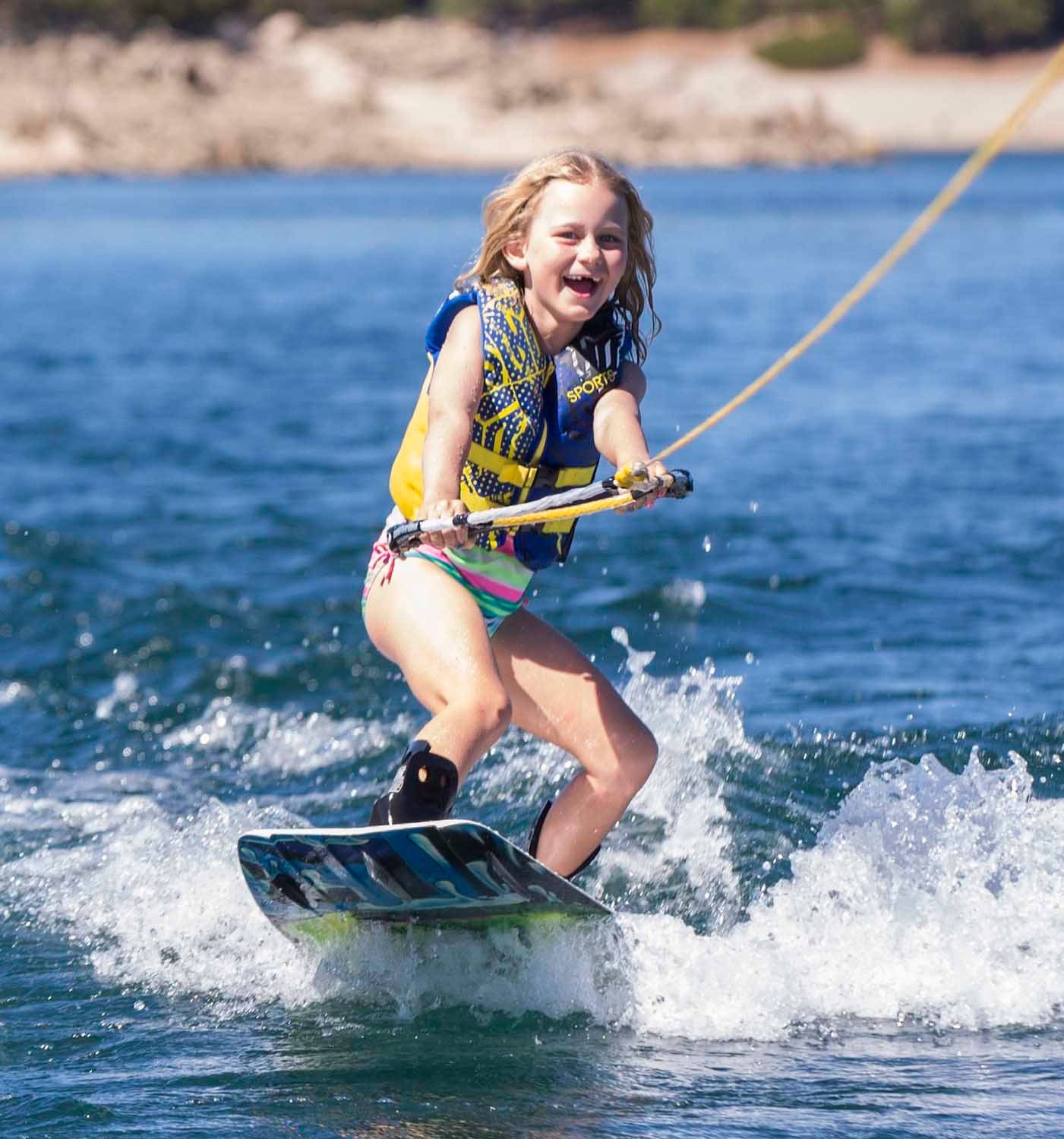 Cute Girl Wakeboarding Water Ski Lesson Wallpaper