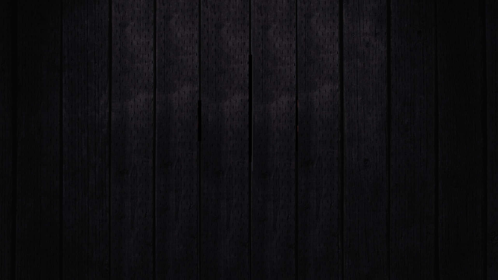 a black wooden background with a light shining on it