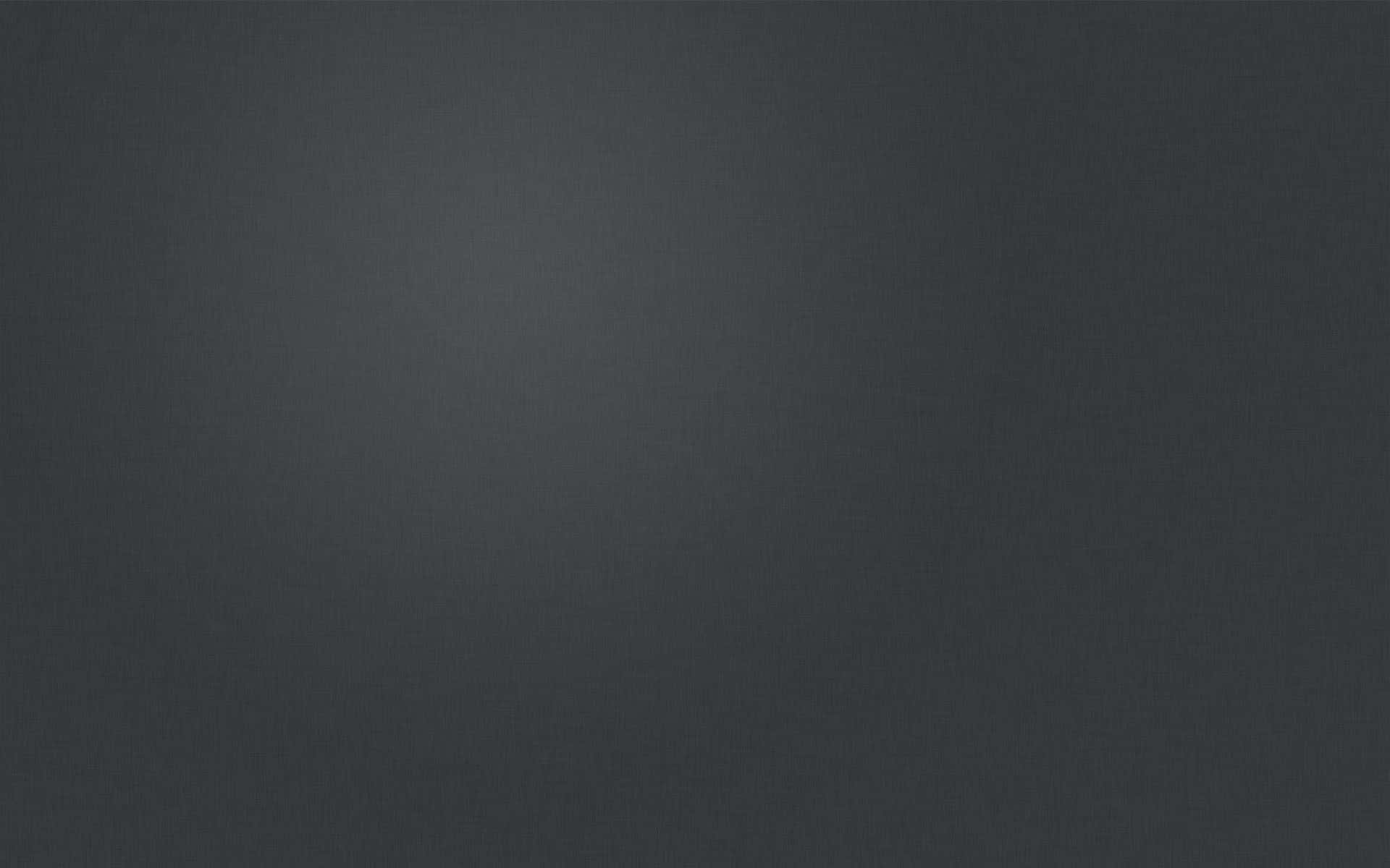 An abstract background of solid dark grey color
