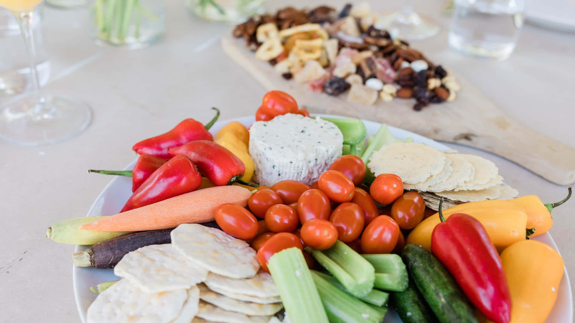 A Plate Of Vegetables And Crackers On A Table Wallpaper