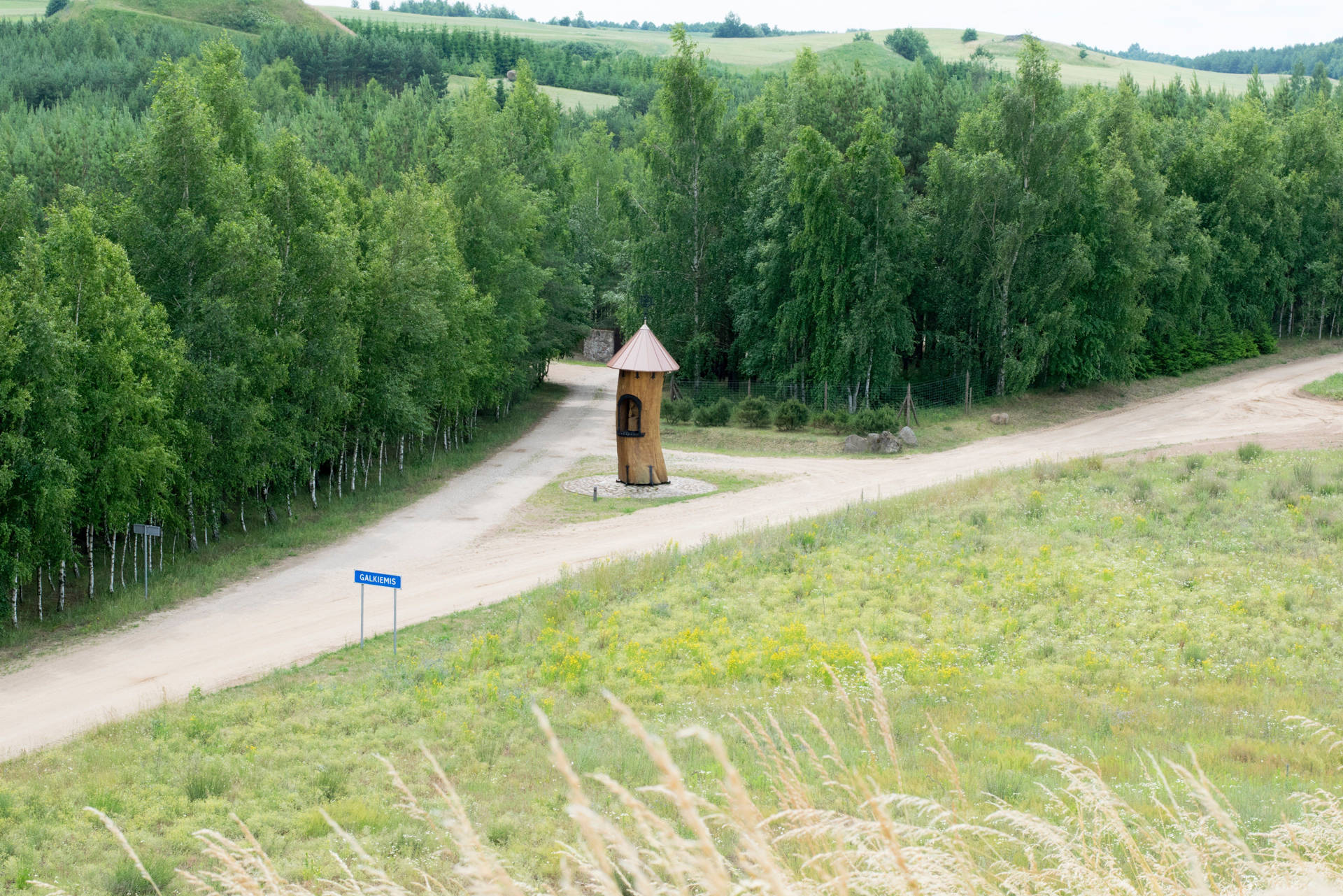 Dirt Road With Wooden Tower In Lithuania Wallpaper