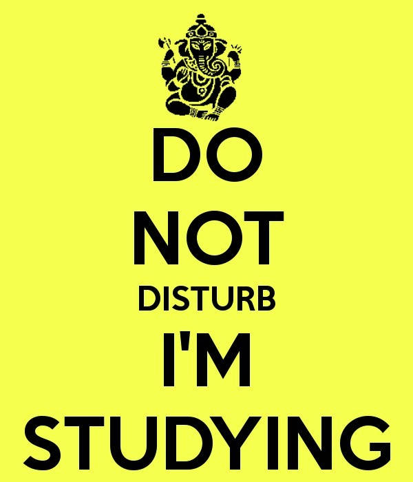 Caption: Student Engrossed In Study With Do Not Disturb Sign Wallpaper