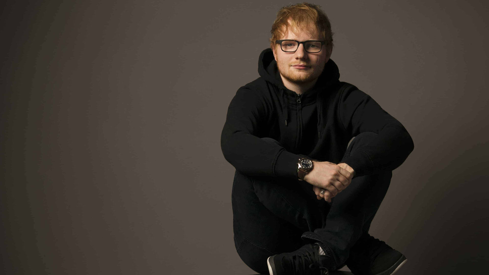 Multi-platinum singer-songwriter Ed Sheeran in a black hoodie Wallpaper