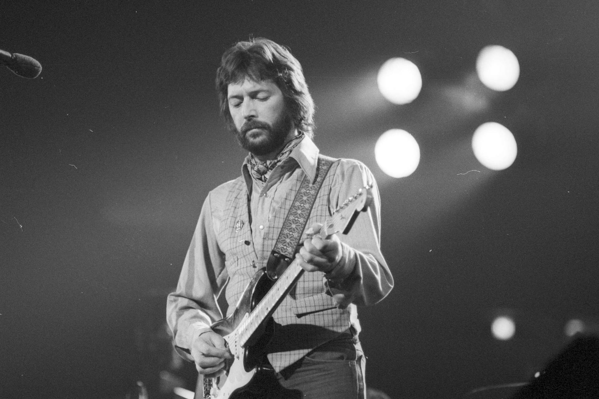 Eric Clapton Playing Guitar On Stage Wallpaper