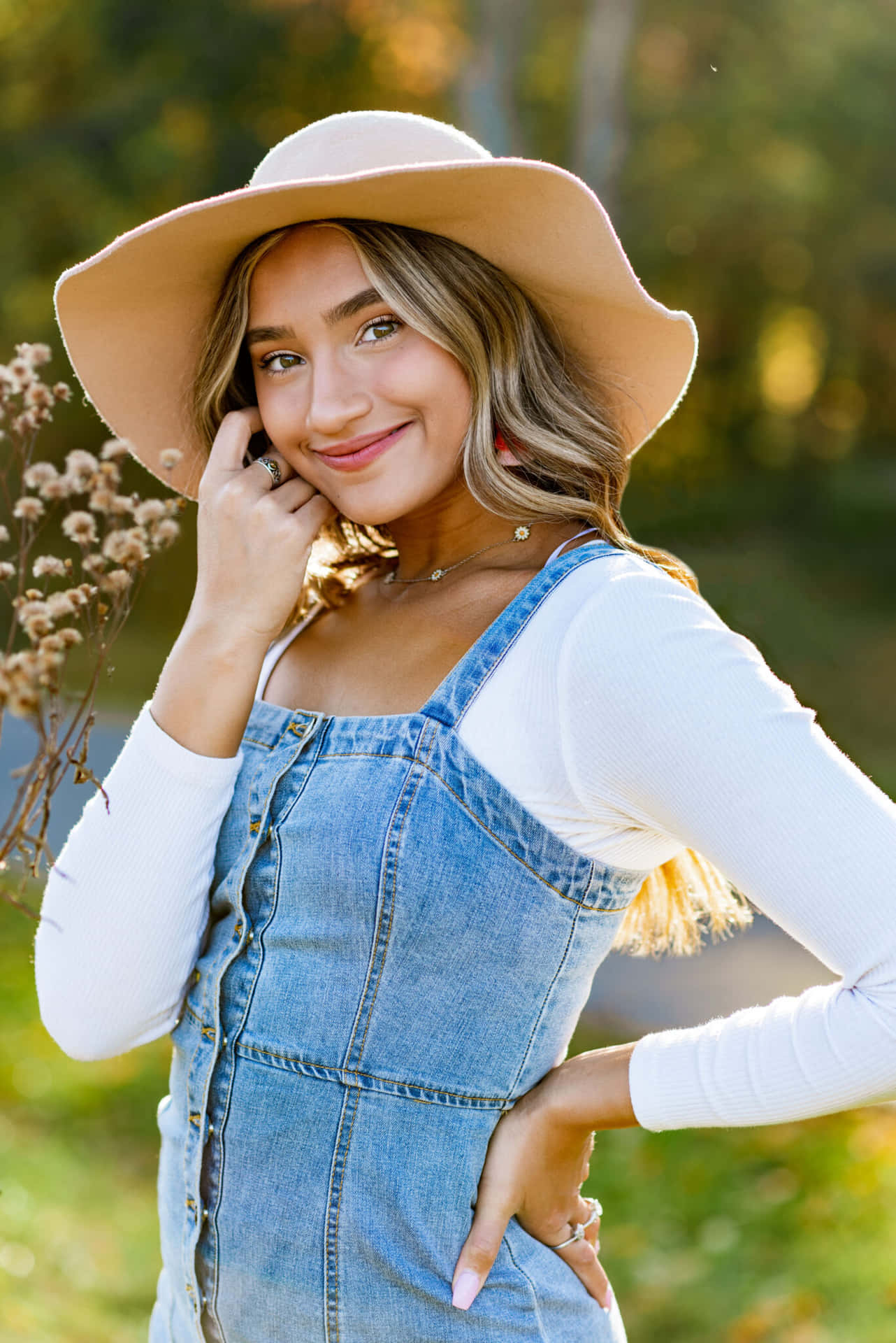 A Beautiful Woman In A Denim Overall Dress And Hat