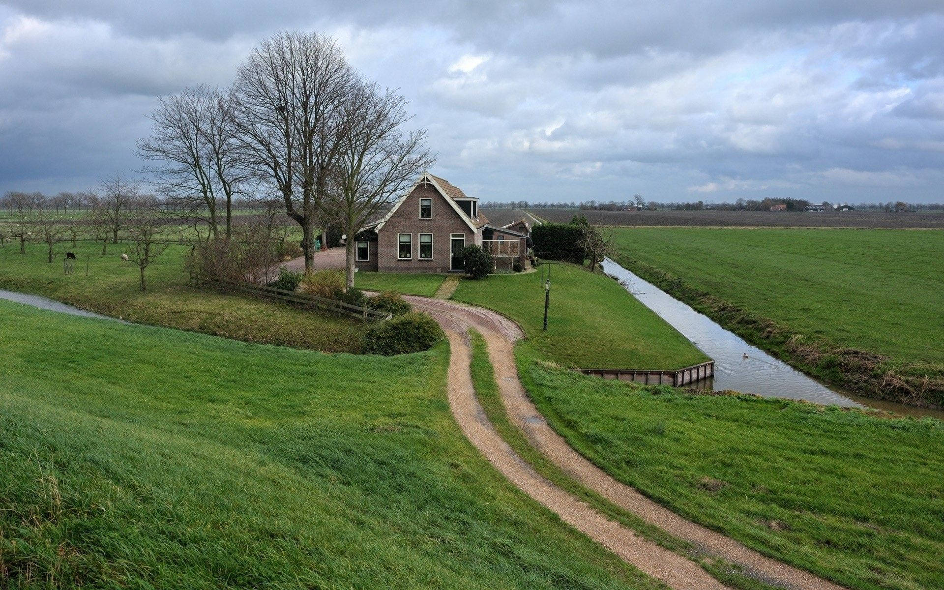 Farmhouse Beside An Irrigation Canal Wallpaper