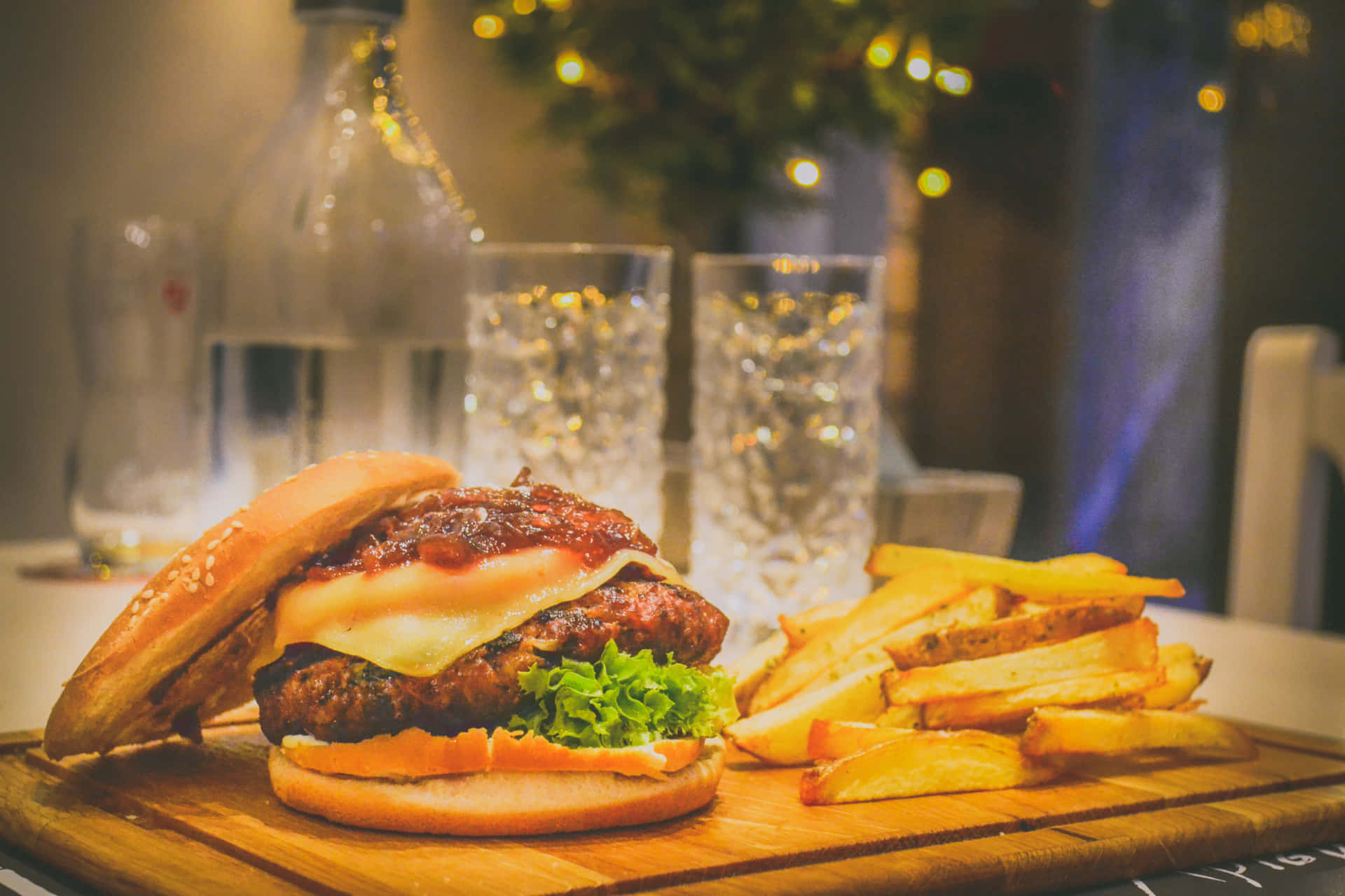 A Burger And Fries On A Wooden Cutting Board
