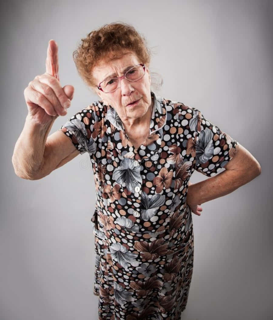 An Old Woman Pointing Her Finger At Something