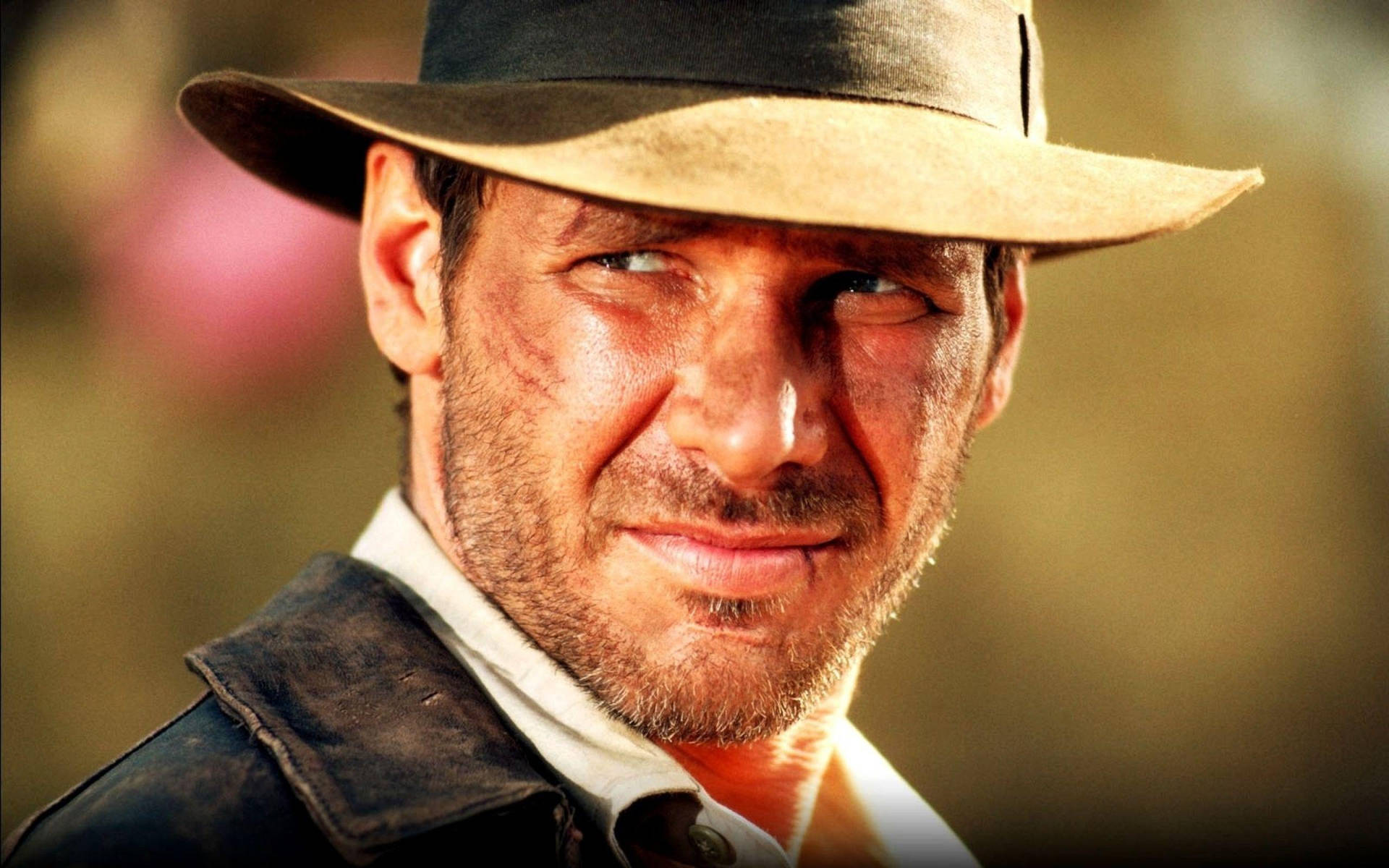 Harrison Ford as Indiana Jones in Classic Action Adventure Wallpaper