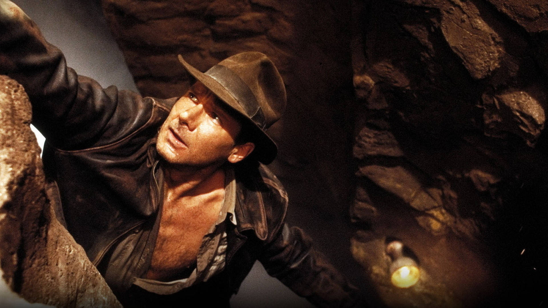 Harrison Ford as Indiana Jones on the Edge of a Cliff Wallpaper