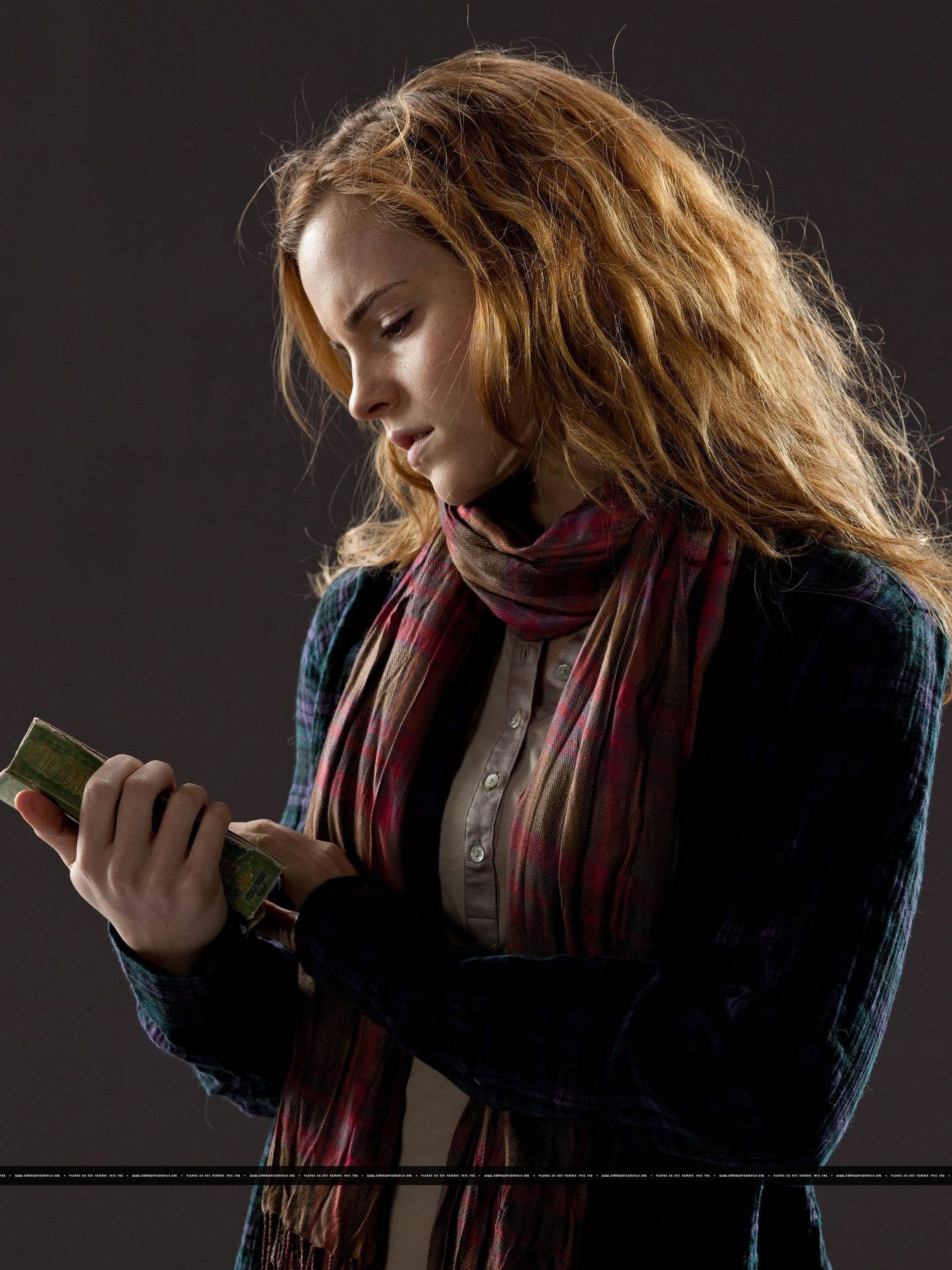 Hermione Granger taking a break from magical studies. Wallpaper