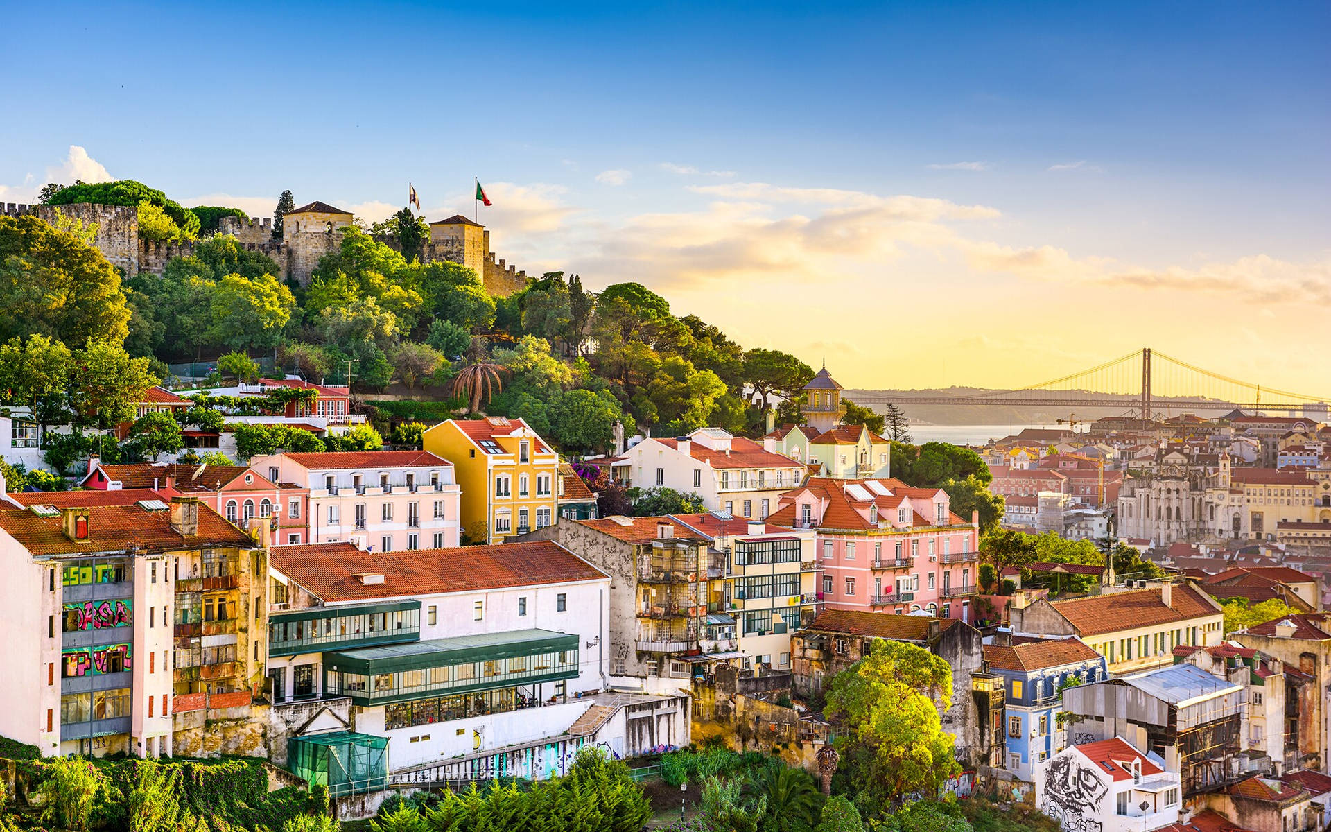 Picturesque View of Hillside Homes Amidst Lush Greenery in Lisbon Wallpaper