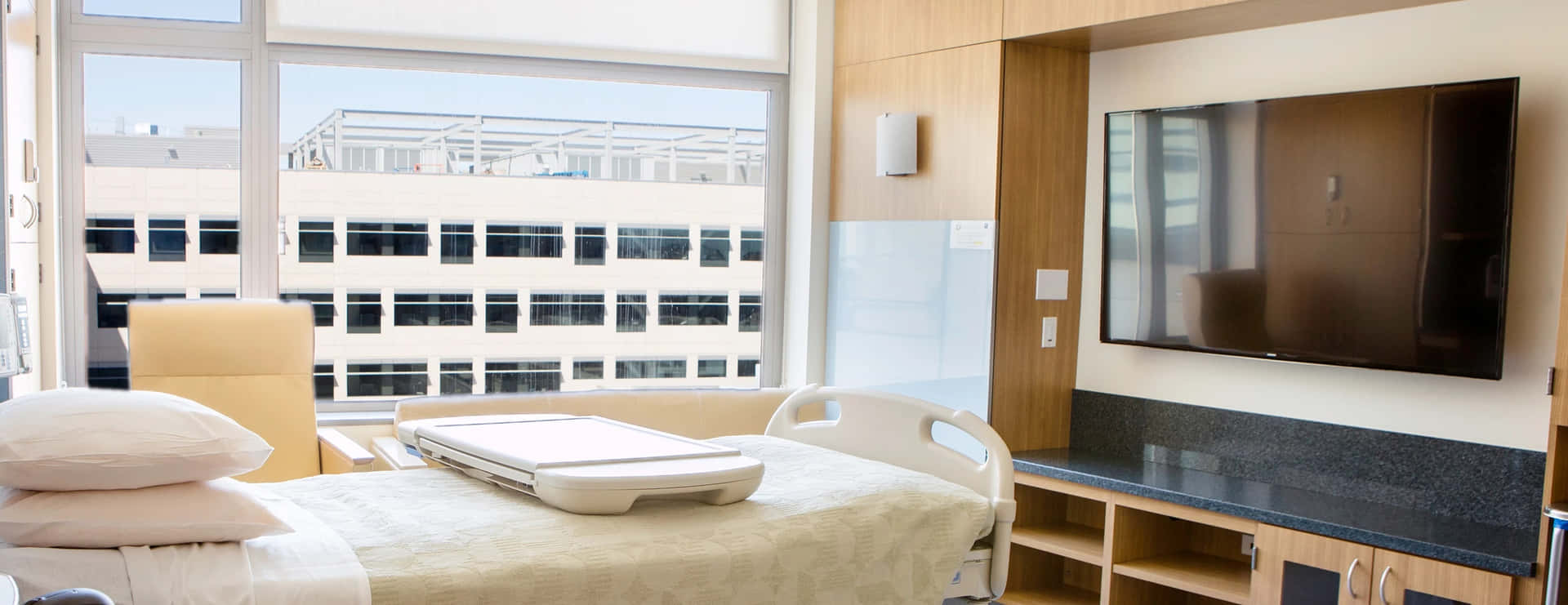 A Hospital Room With A Bed And A Television