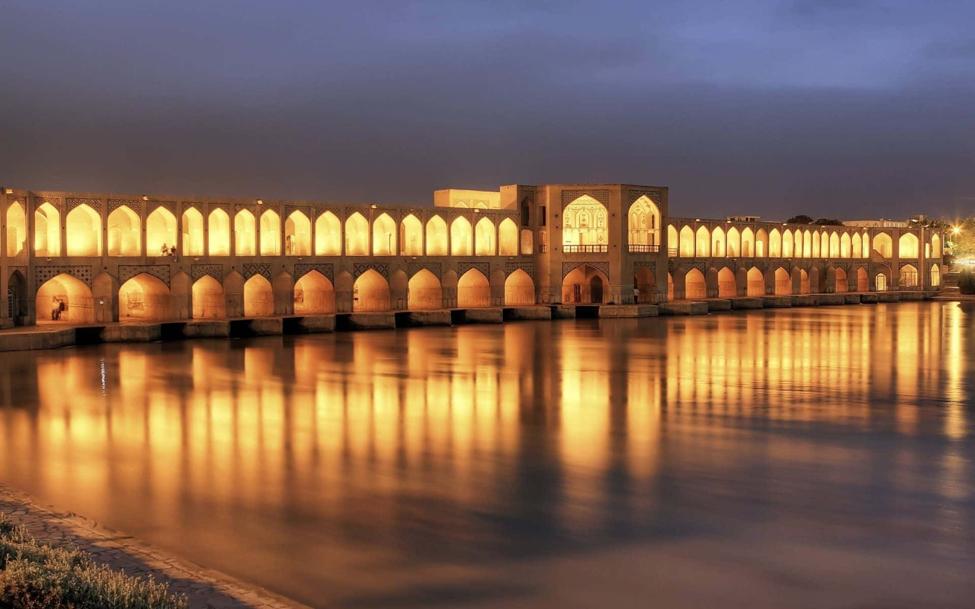 The Enchanting Khajoo Bridge in Isfahan at Night Wallpaper