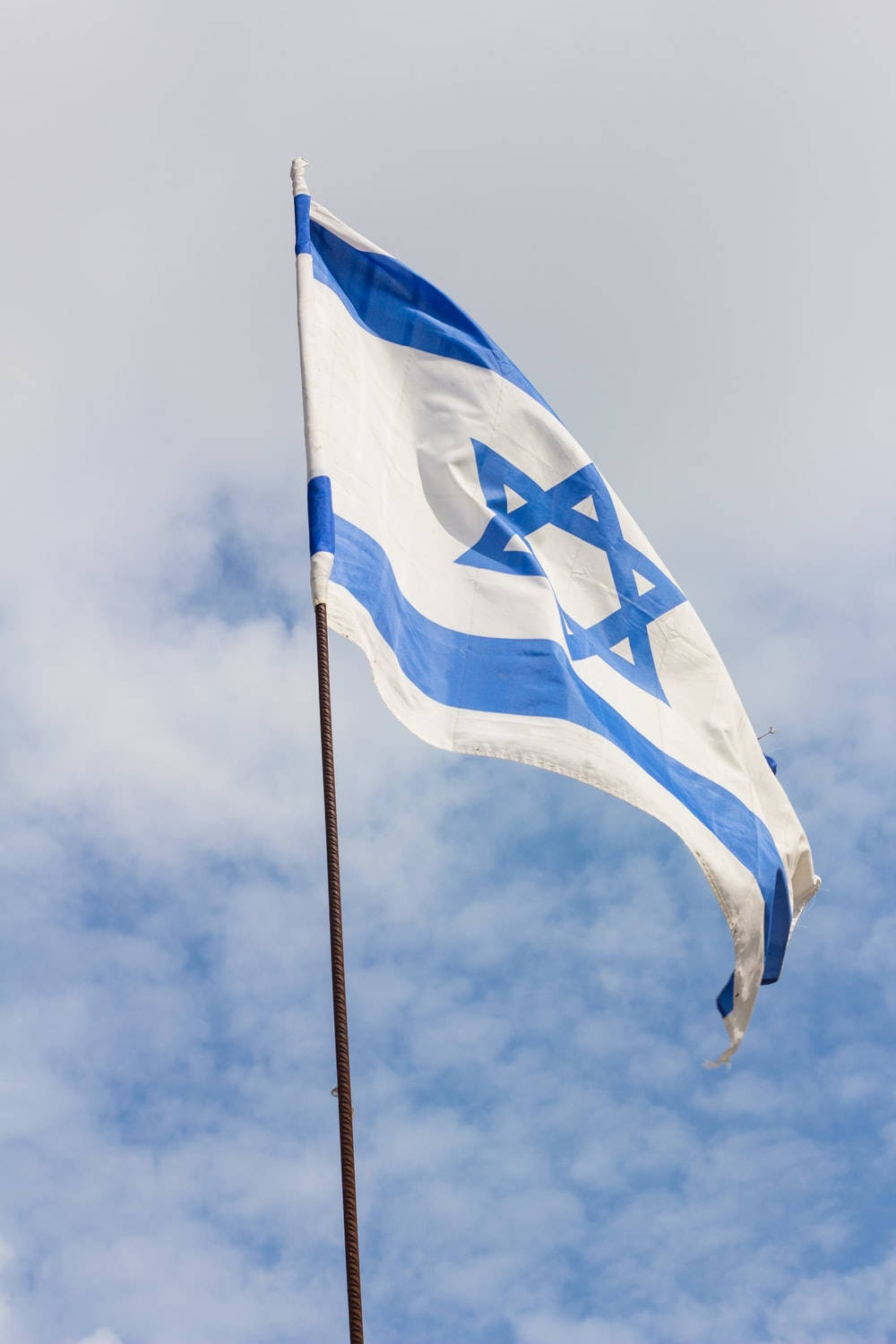 The National Flag of Israel Proudly Displayed on a Metal Rod Wallpaper