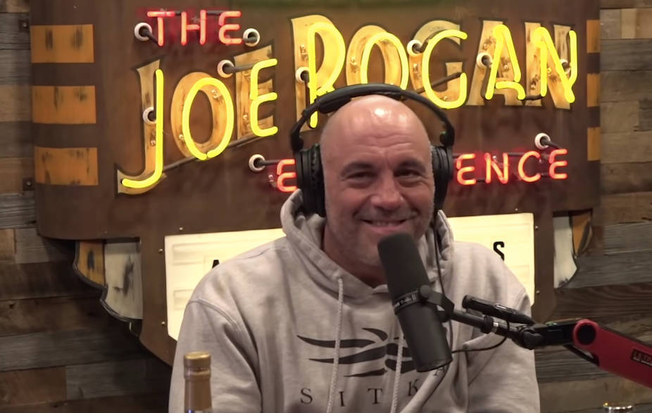 Podcast Host Joe Rogan with Show Logo Wallpaper
