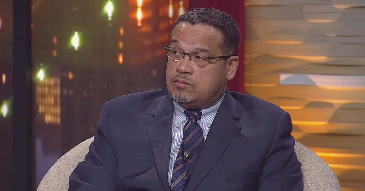 Keith Ellison Sitting During Live Interview Wallpaper