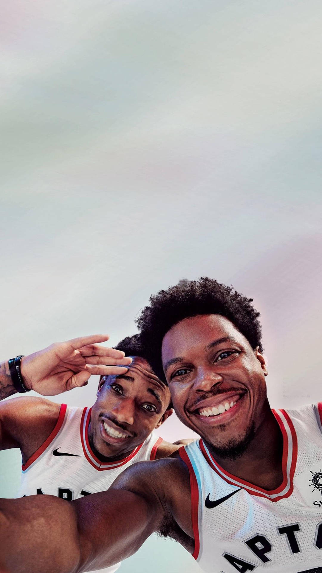 NBA stars Kyle Lowry and DeMar DeRozan sharing a light moment with a selfie. Wallpaper