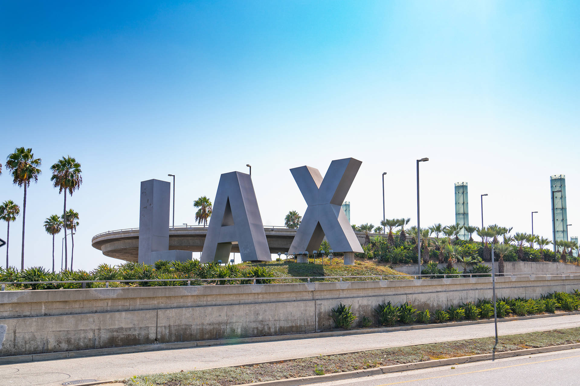 View of Lax signage against a clear blue sky Wallpaper