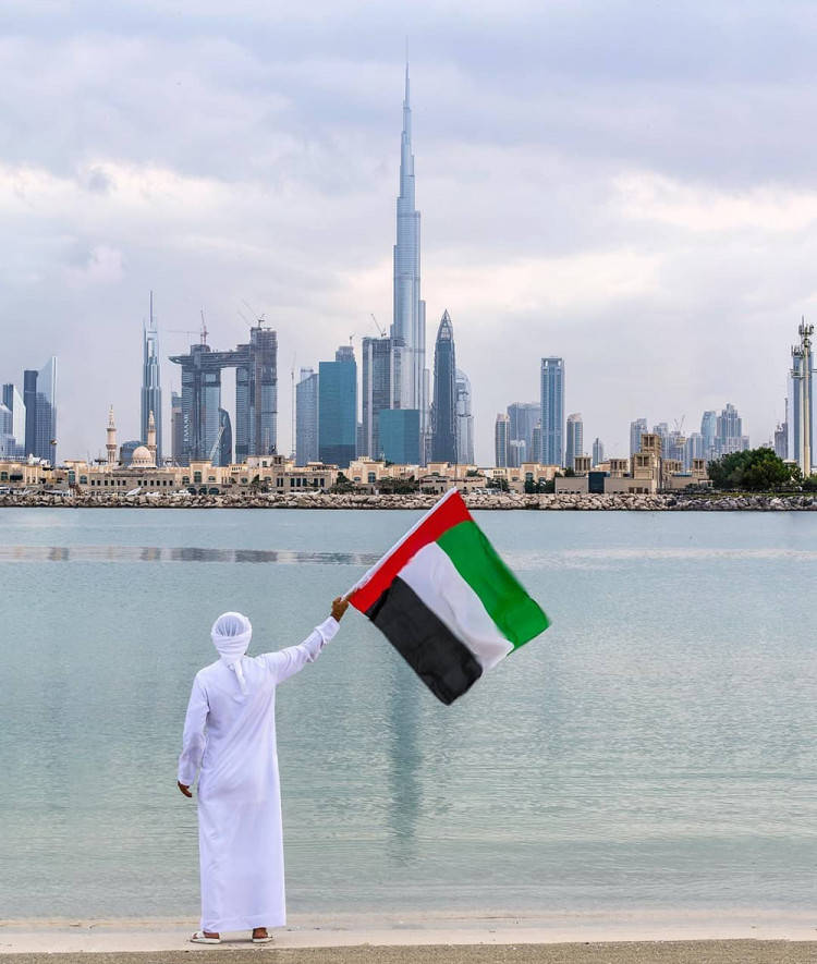 Man Holding UAE Flag Wallpaper