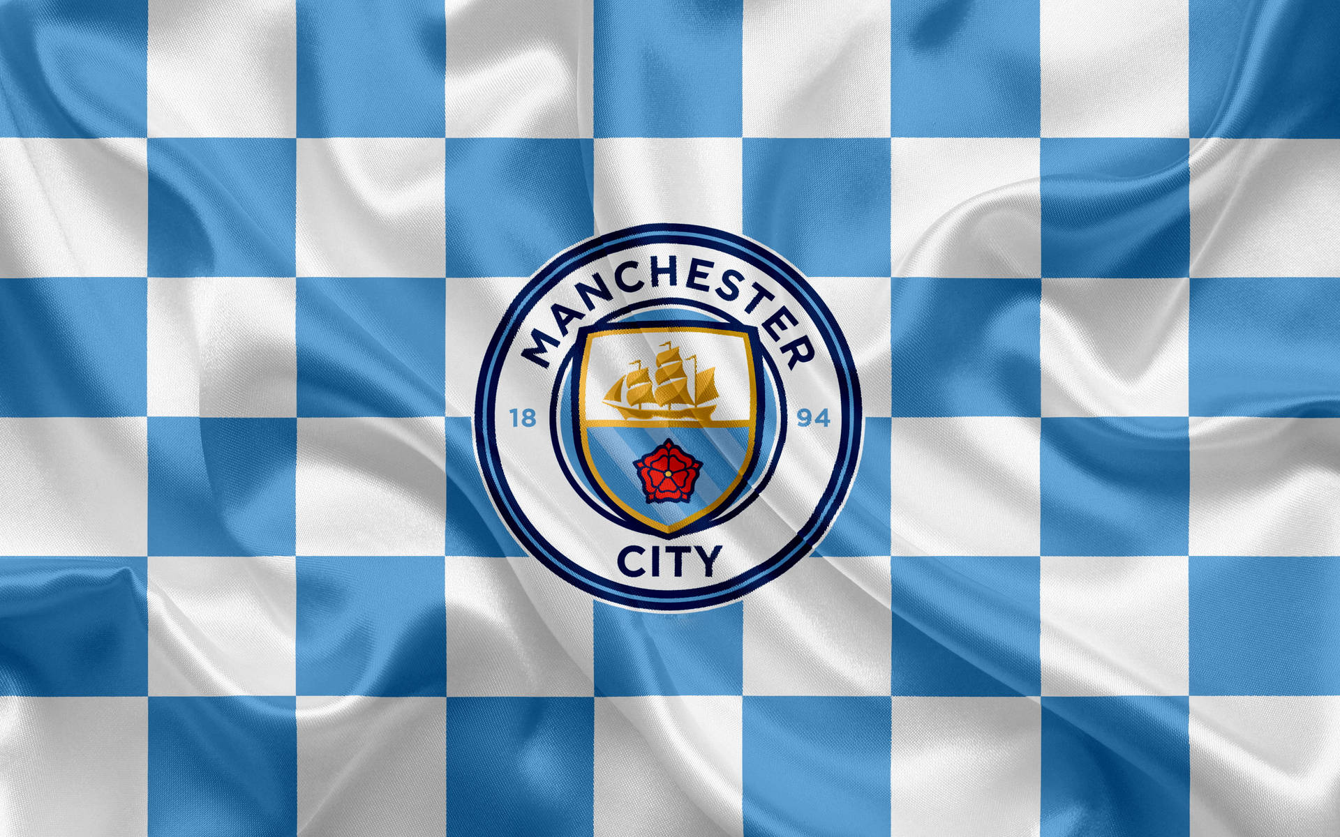 Manchester City Logo On Checkered Cloth Wallpaper
