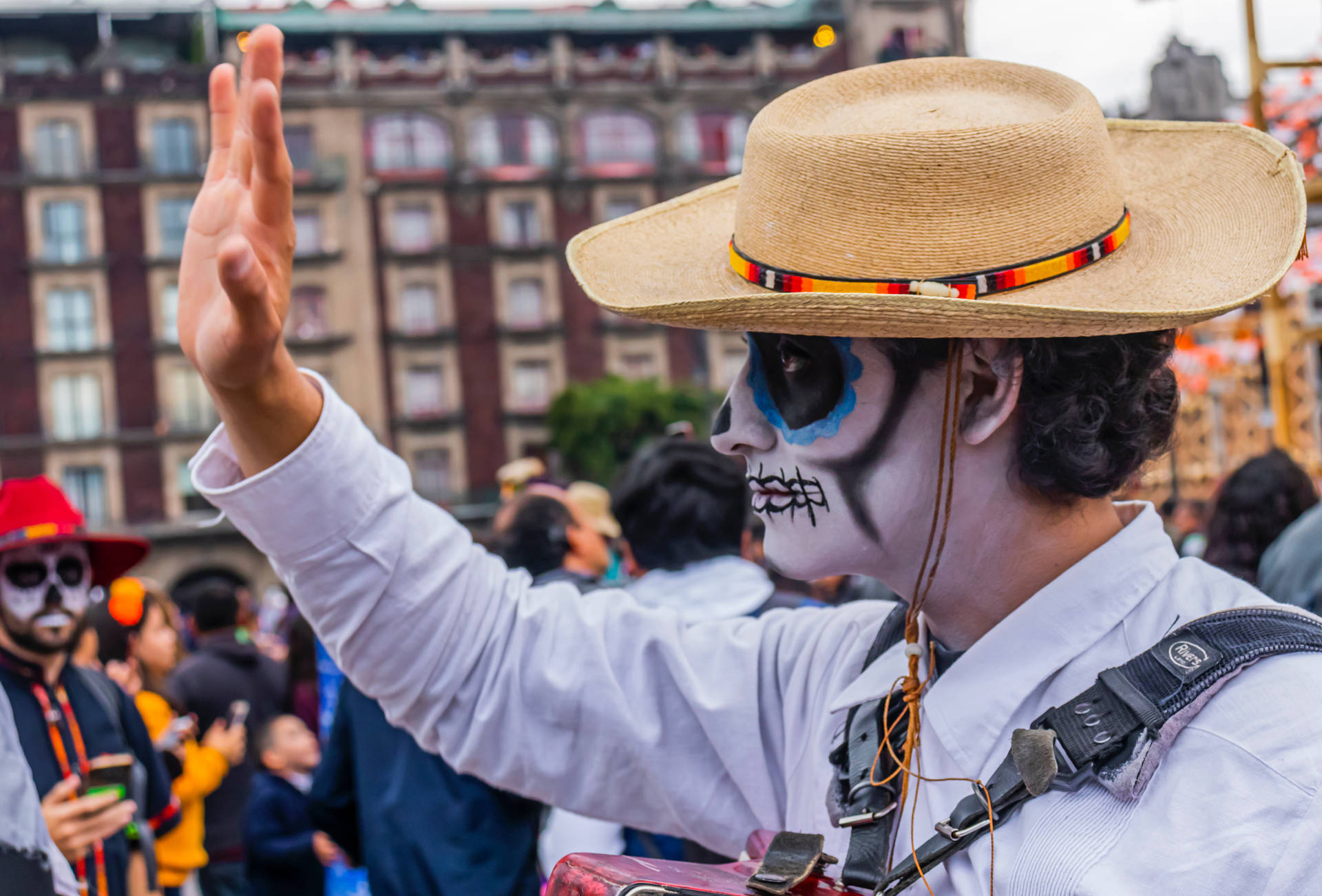 A cheerful Mexican man waving to a crowd Wallpaper