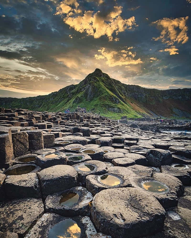 Majestic Scene of the Giant's Causeway and Mountain Landscape in Northern Ireland Wallpaper