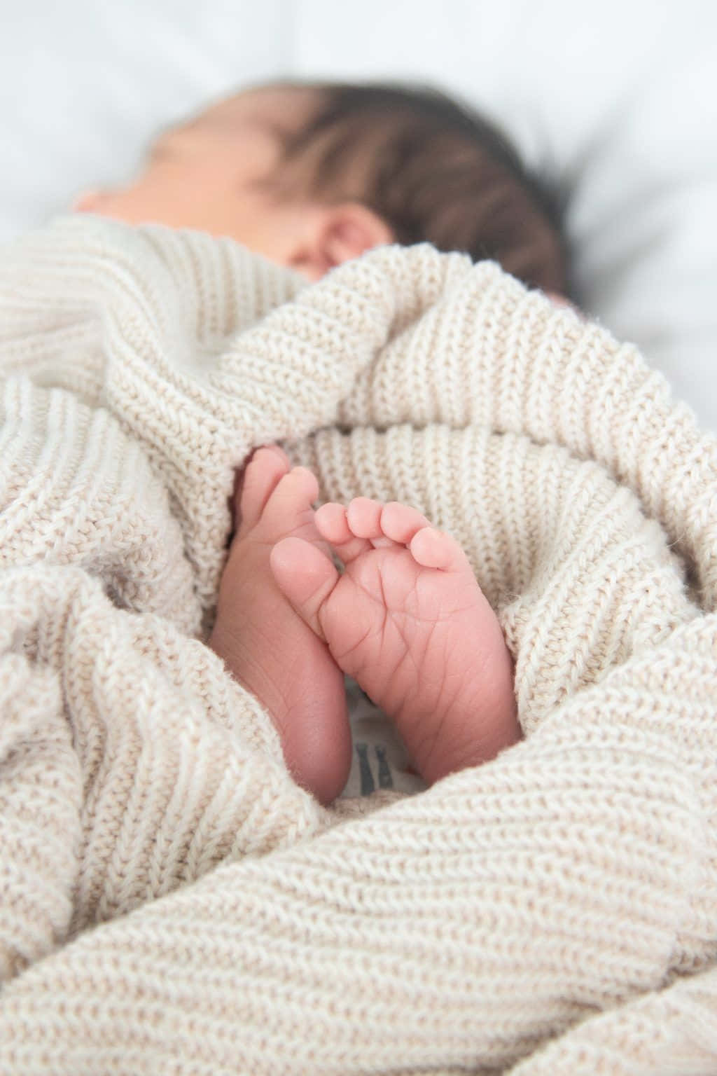 A tender moment as a newborn sleeps peacefully