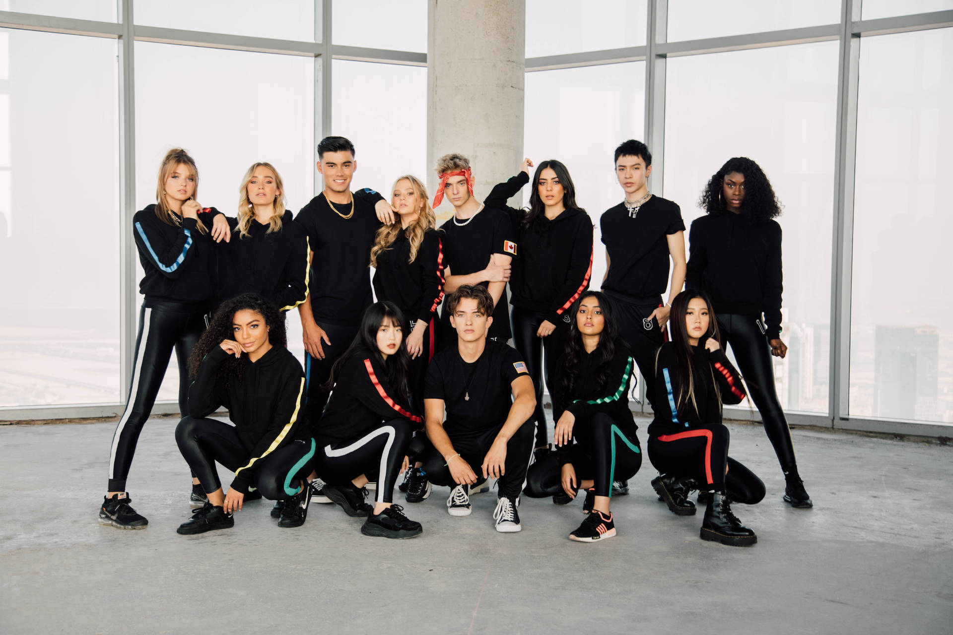 Now United Members Showcasing Unity and Diversity in Black Attire Wallpaper
