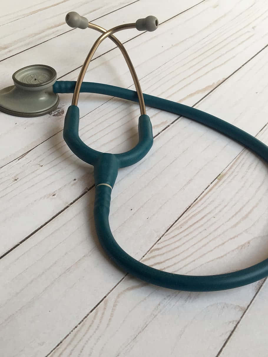 A Stethoscope On A Wooden Table Wallpaper