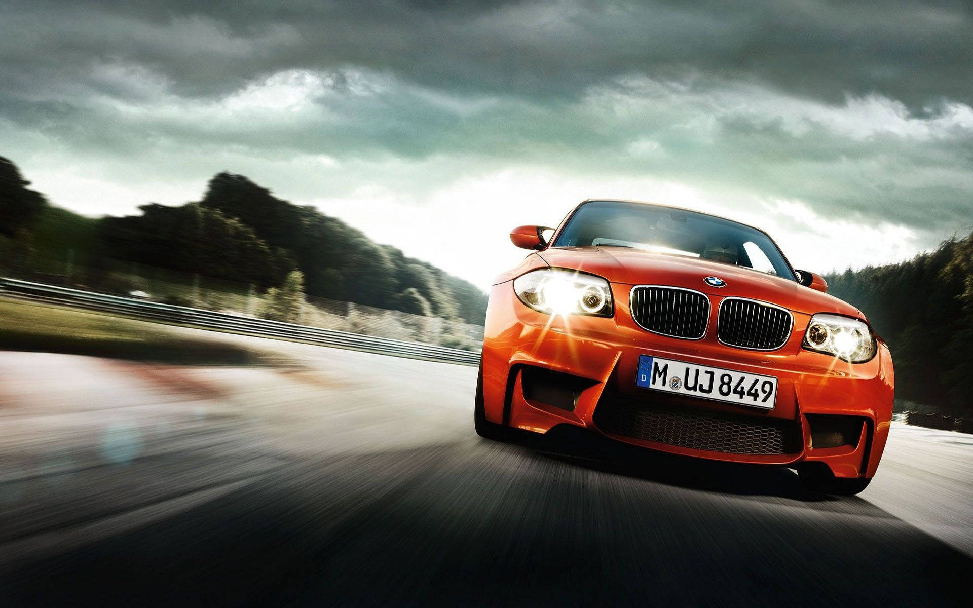 "A sporty orange BMW M4 delivers performance and style." Wallpaper