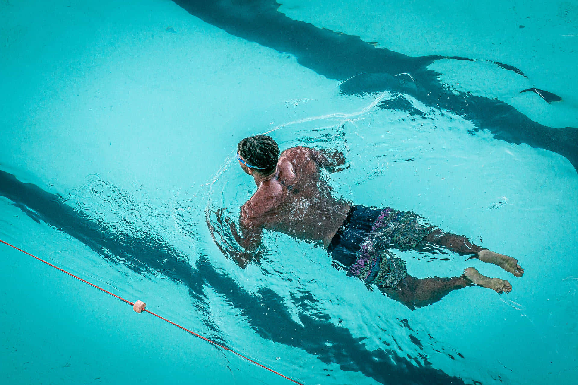 A Man Swimming In A Pool