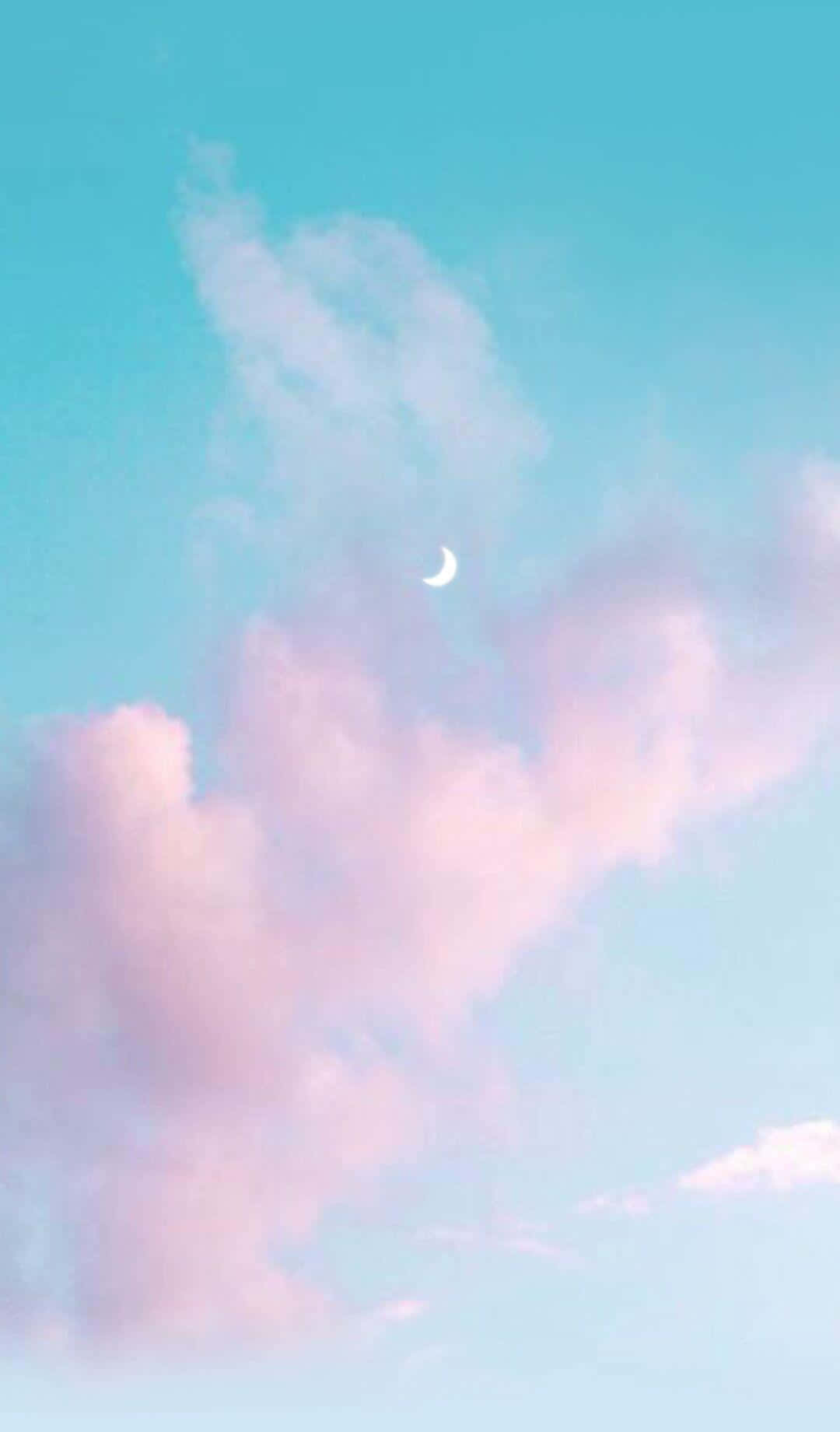 A Pink And Blue Sky With Clouds And A Crescent