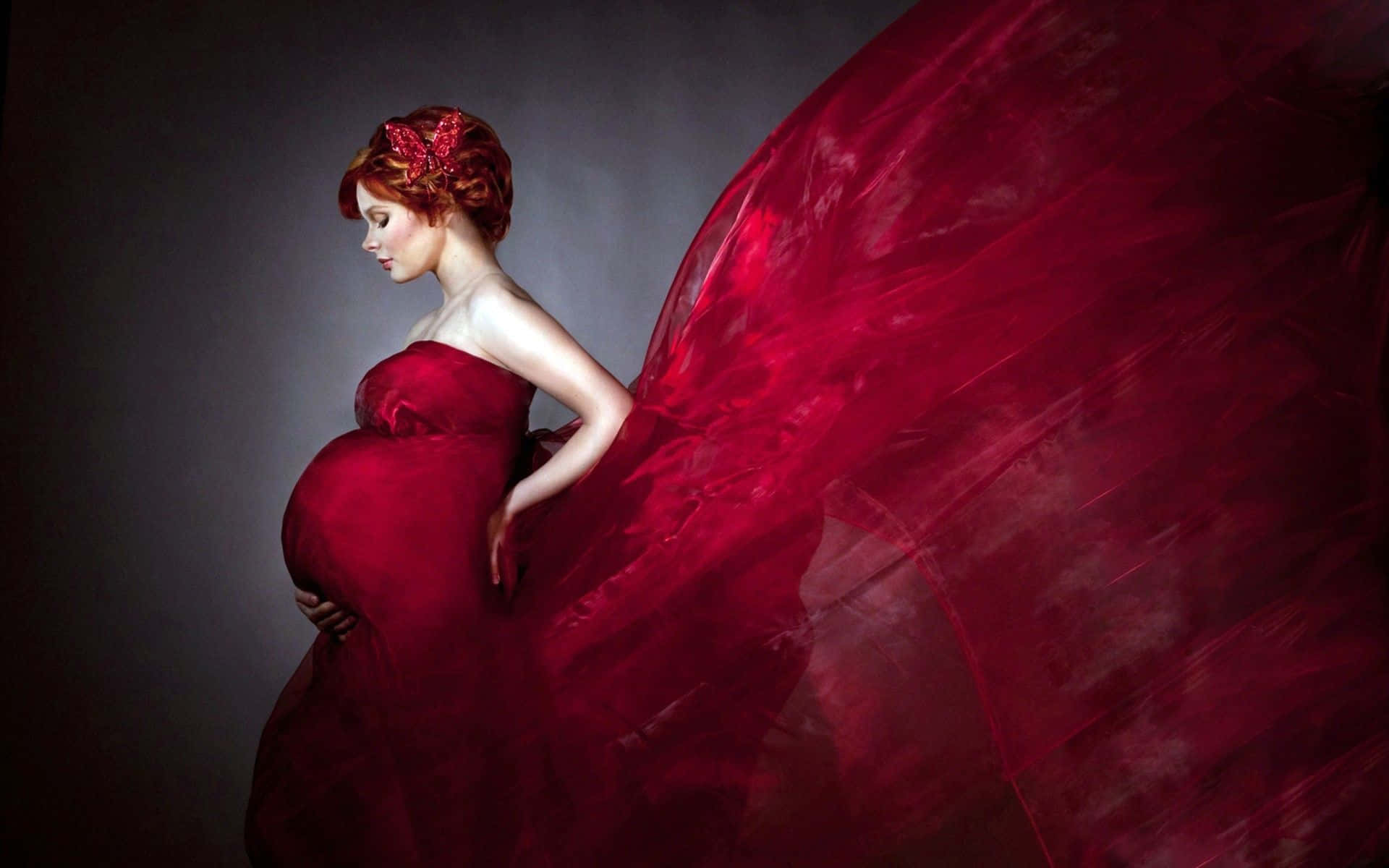 Caption: Blooming in Red - A Radiant Pregnant Woman Wallpaper