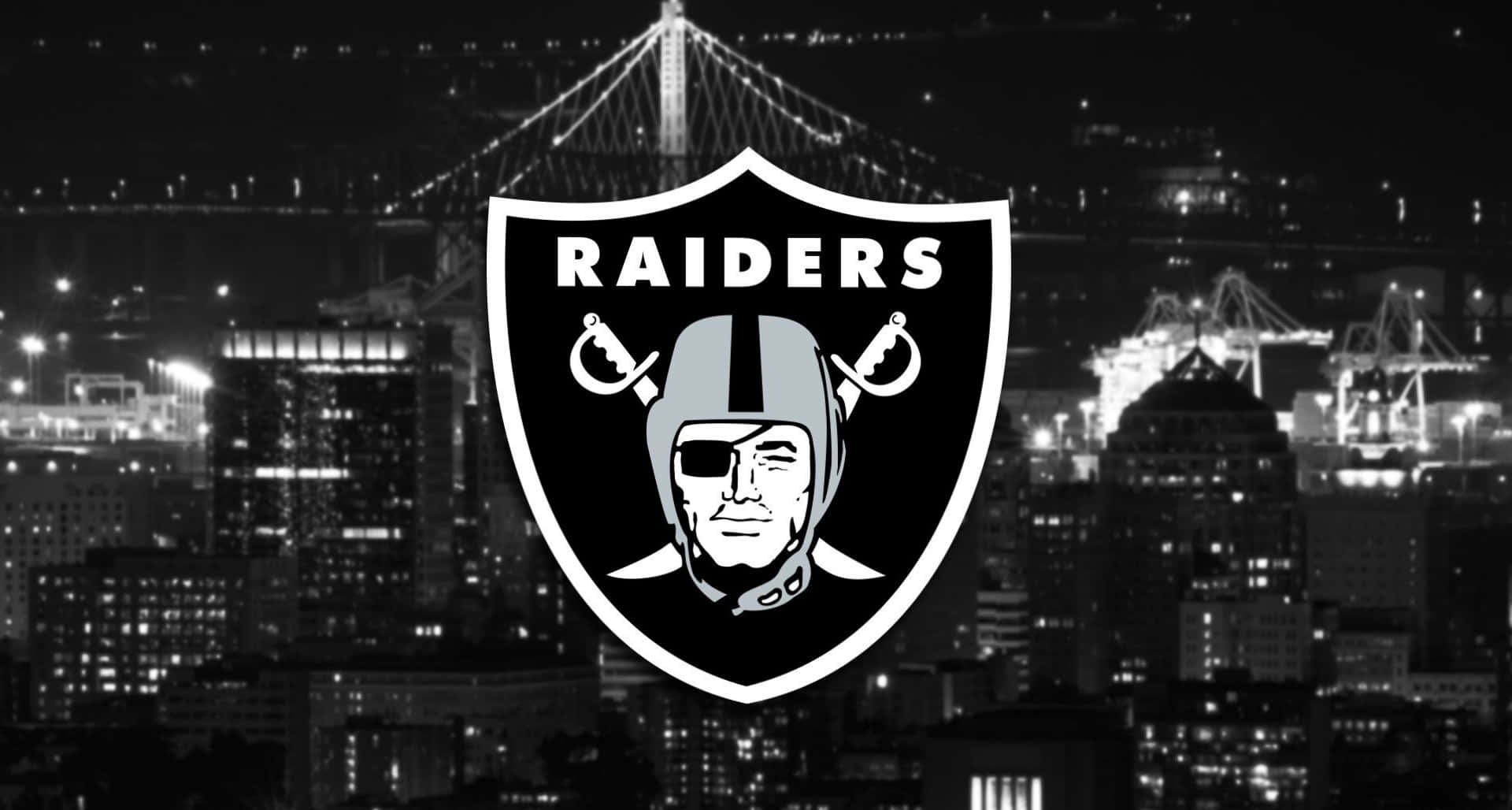 Raiders Logo On Night Cityscape Wallpaper