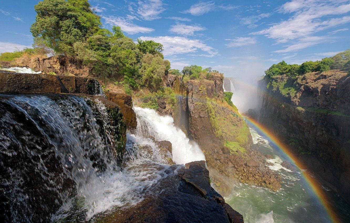 Rainbow Over A Falls In Zimbabwe Wallpaper