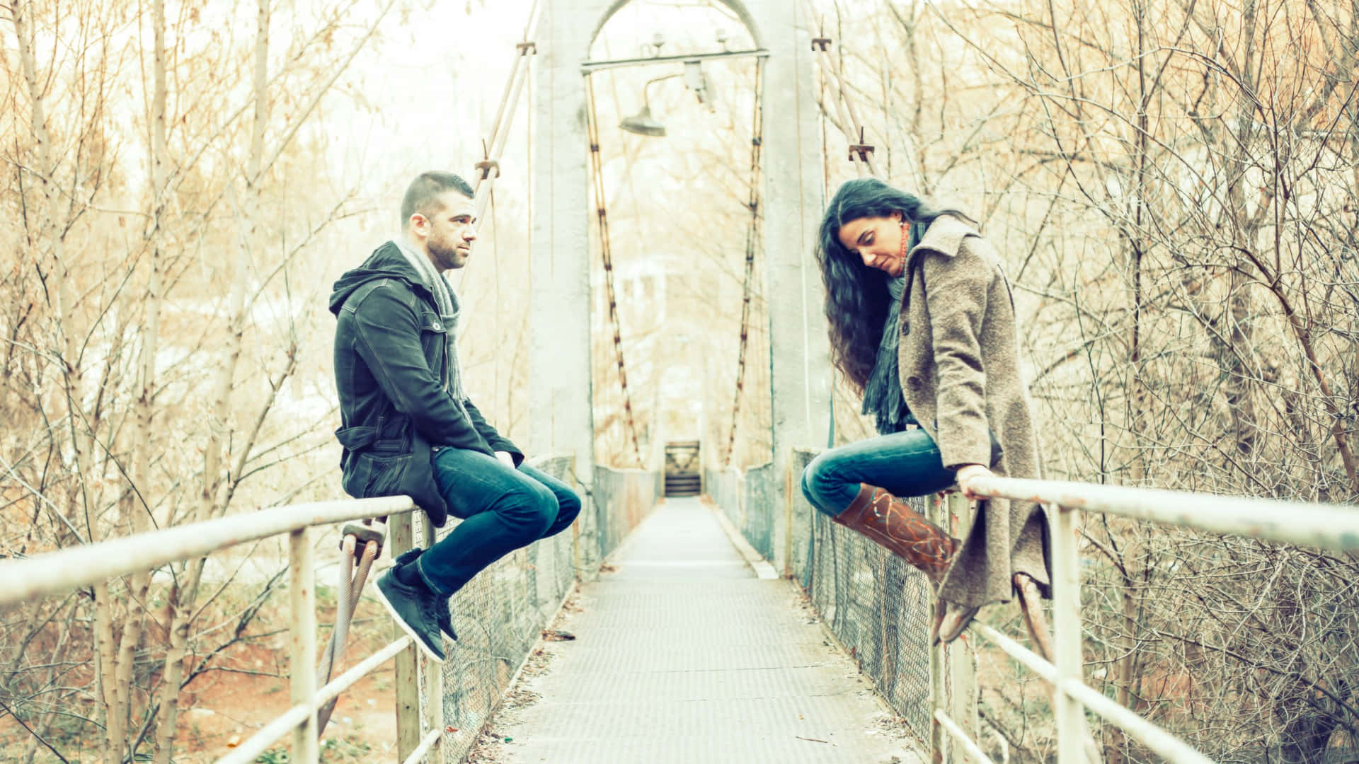 Sad Couple Sitting On The Bridge Wallpaper