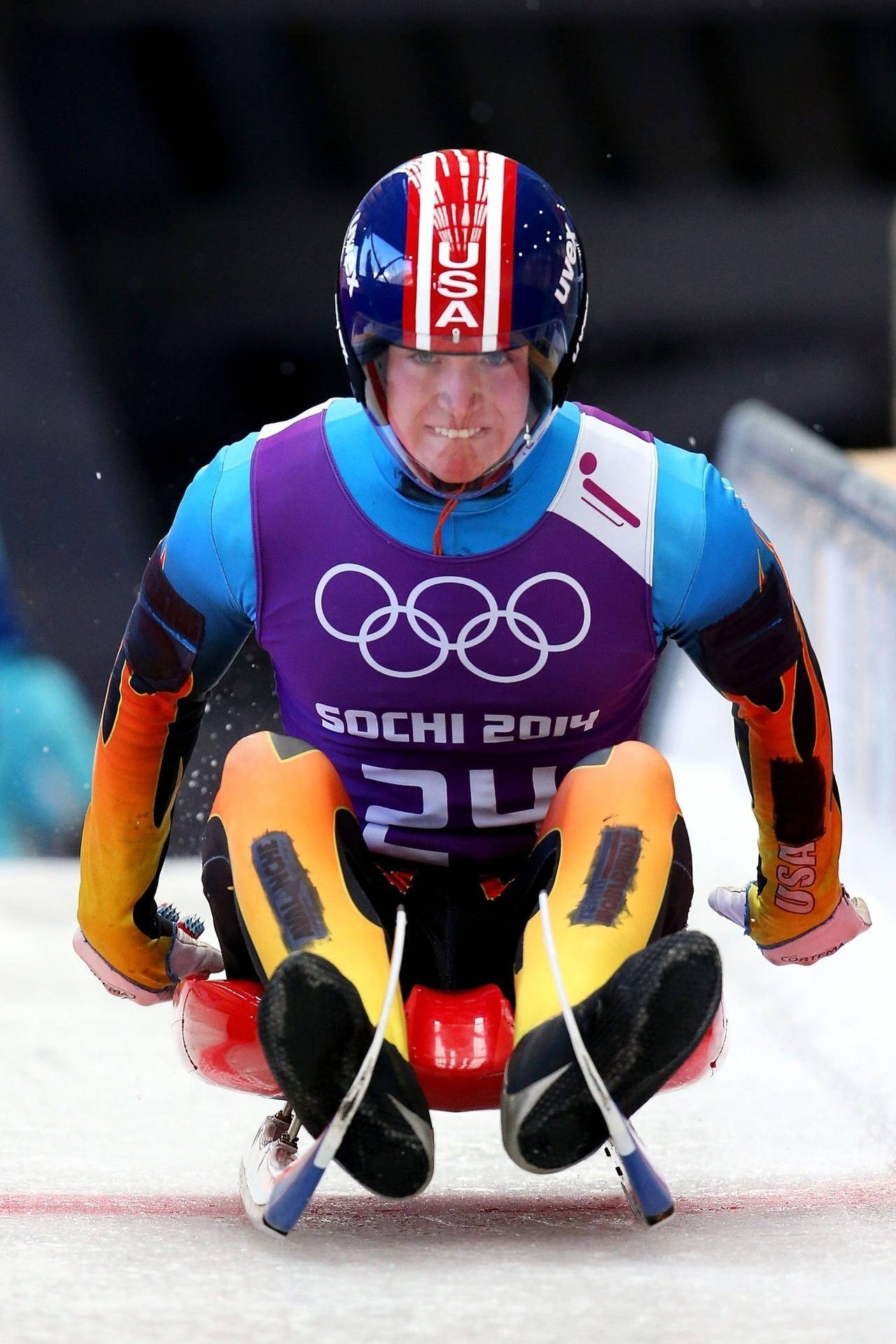 Intense Action Moment of Tucker West in the Luge Event at Sochi Olympics Wallpaper