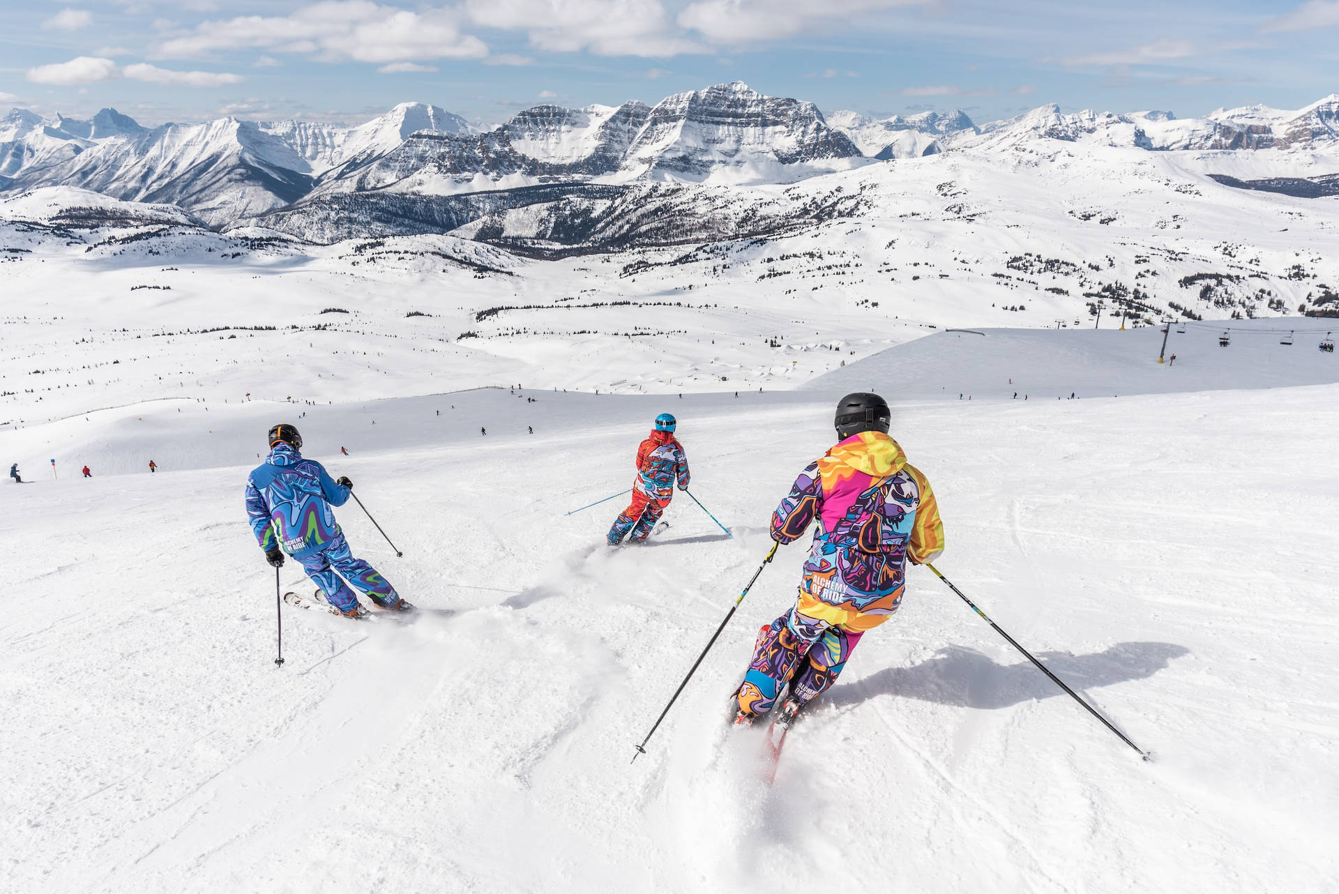 Sport Athletes Skiing Down A Mountain Wallpaper
